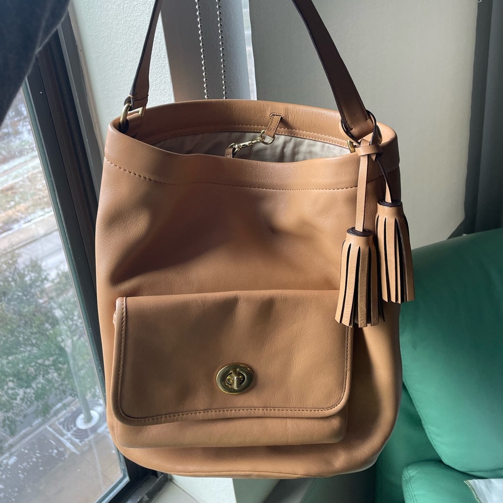 Coach bucket bag with tassel. Comes with dust bag.